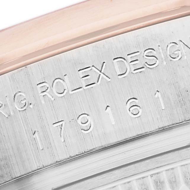The image shows a close-up of the engraved side of a Rolex Datejust 179161 Women
s Steel and Gold (two tone) Black Dial 179161 Women
s Steel and Gold (two tone) Black Dial watch, focusing on the model number.