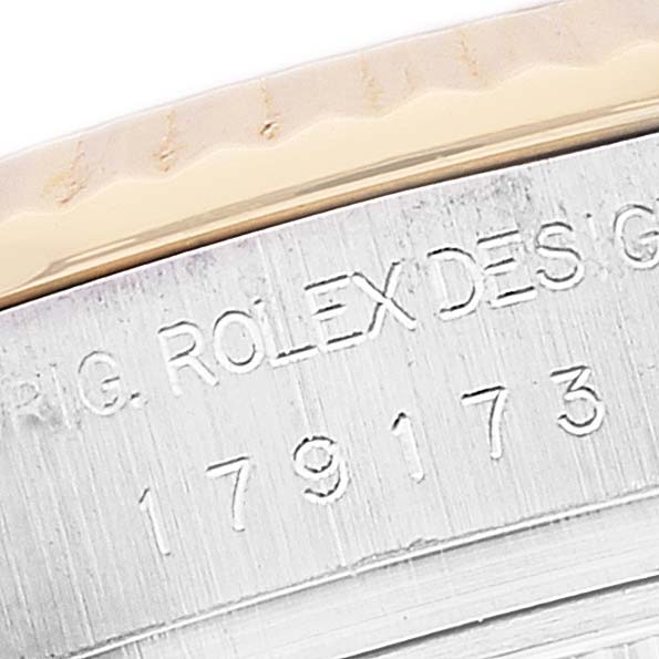 A close-up of the Rolex Datejust 179173 Women's Steel and Gold (two tone) Beige Dial 179173 Women's Steel and Gold (two tone) Beige Dial watch showing part of the case with engraved text and numbers.