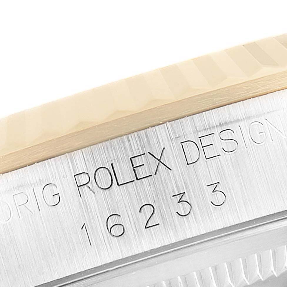 The image shows a close-up of the engraved side case of a Rolex Datejust 16233 Men
s Steel and Gold (two tone) Black Dial 16233 Men
s Steel and Gold (two tone) Black Dial watch, displaying the model number 16233.