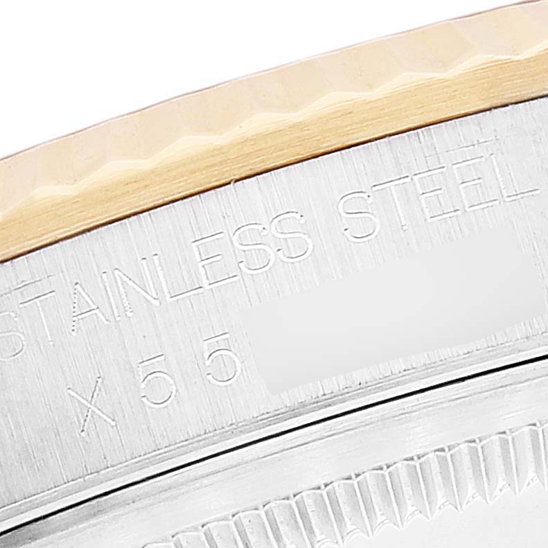 This close-up shows the engraved stainless steel casing near the bezel of a Rolex Datejust 16233 Men's Steel and Gold (two tone) Black Dial 16233 Men's Steel and Gold (two tone) Black Dial watch.