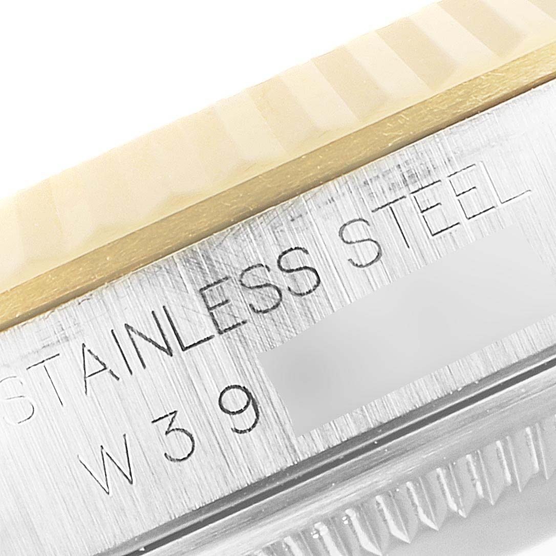 The image shows a close-up of the stainless steel case side and part of the bezel of the Rolex Datejust 16233 Men
s Steel and Gold (two tone) Black Dial 16233 Men
s Steel and Gold (two tone) Black Dial watch.