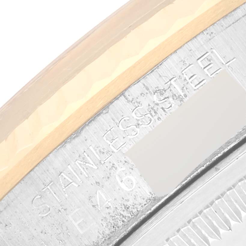 This close-up image shows part of the bezel and engraved inner case of a Rolex Datejust 16233 Men's Steel and Gold (two tone) Champagne Dial 16233 Men's Steel and Gold (two tone) Champagne Dial watch.