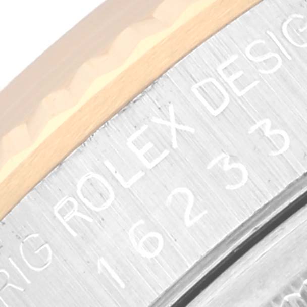 The image shows a close-up of the side engraving on a Rolex Datejust 16233 Men's Steel and Gold (two tone) Champagne Dial 16233 Men's Steel and Gold (two tone) Champagne Dial model, highlighting the brand and serial number.