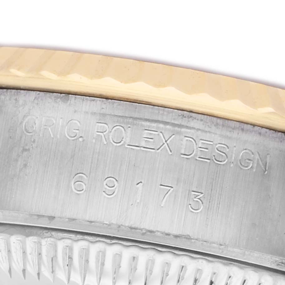 The image shows a close-up of the side of a Rolex Datejust 69173 Women's Steel and Gold (two tone) Champagne Dial watch, focusing on the engraved model number.