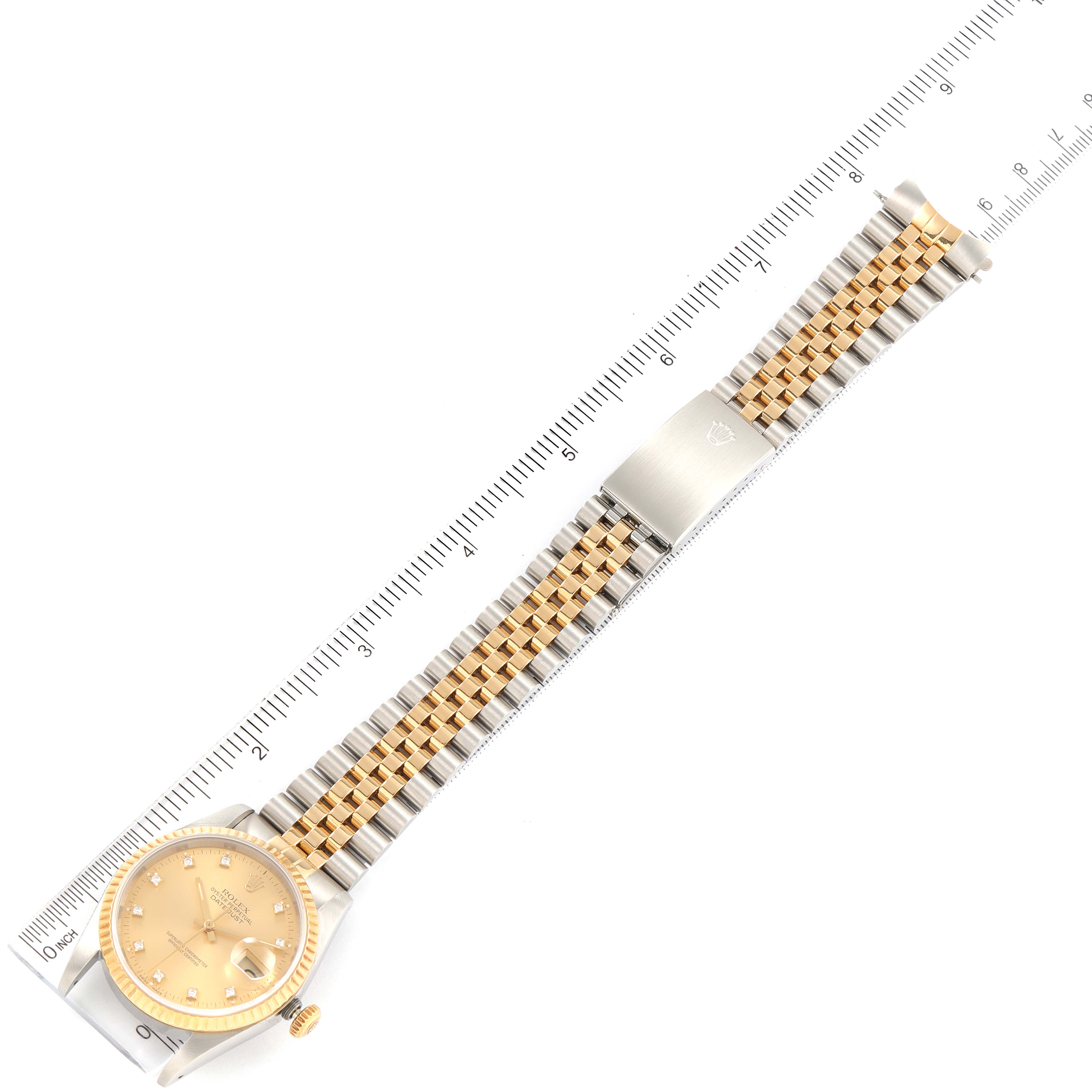 This image shows a Rolex Datejust 16233 Men's Steel and Gold (two tone) Champagne Dial 16233 Men's Steel and Gold (two tone) Champagne Dial watch laid flat with the full bracelet and clasp visible, alongside a metric ruler for scale.