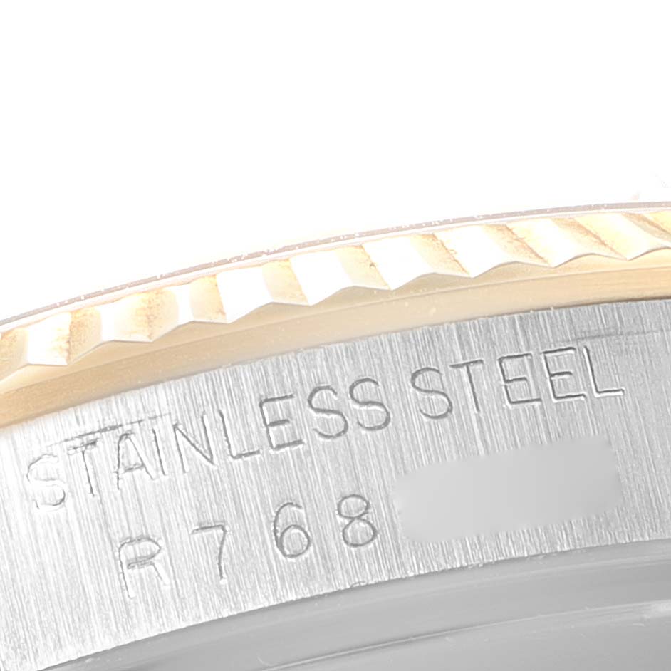 This close-up image shows a part of the bezel and inner rim engraving of a Rolex Datejust 16233 Men's Steel and Gold (two tone) Champagne Dial 16233 Men's Steel and Gold (two tone) Champagne Dial watch.
