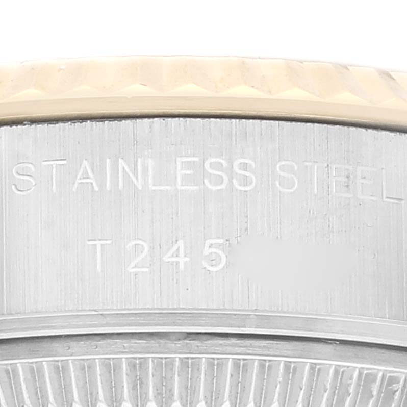 This image shows a close-up of the casing of a Rolex Datejust 69173 Women's Steel and Gold (two tone) Champagne Dial 69173 Women's Steel and Gold (two tone) Champagne Dial watch, highlighting the stainless steel marking and part of the bezel.