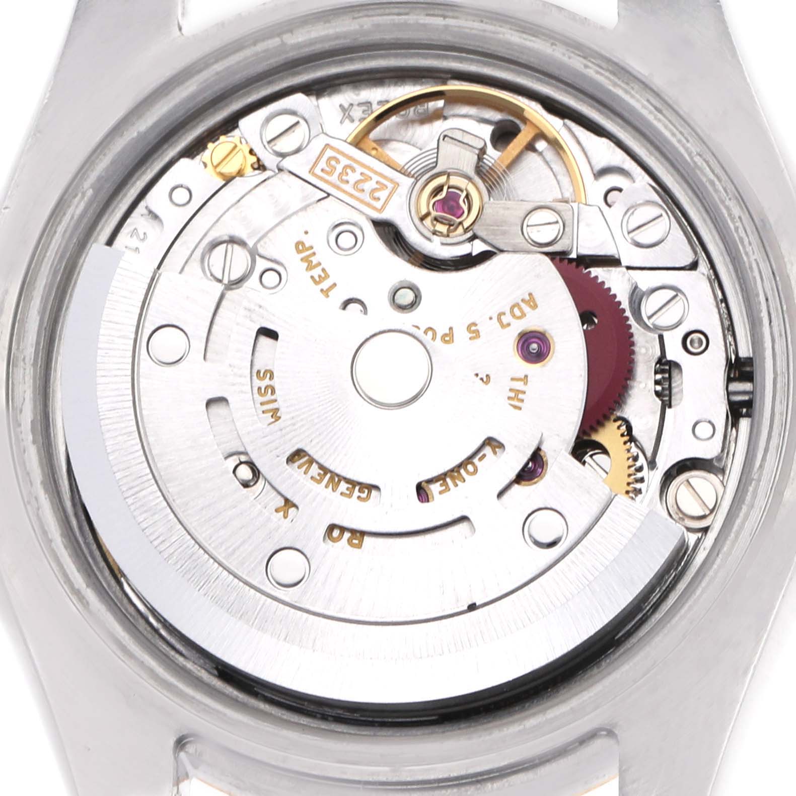 The image shows the movement of a Rolex Datejust 179173 Women's Steel and Gold (two tone) Champagne Dial watch from a rear angle, highlighting the rotor and intricate gears.