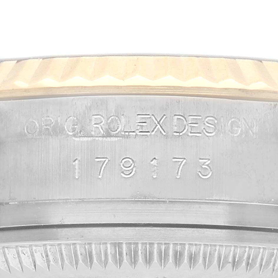 The image shows a close-up of the side engraving and bezel of a Rolex Datejust 179173 Women's Steel and Gold (two tone) Champagne Dial watch.