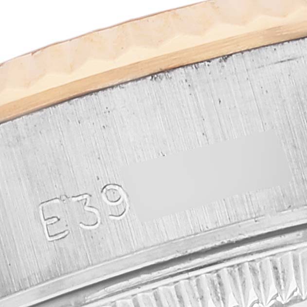 This image shows a close-up of the side of the bezel and case of a Rolex Datejust 69173 Women's Steel and Gold (two tone) Champagne Dial 69173 Women's Steel and Gold (two tone) Champagne Dial watch, displaying part of its serial number.
