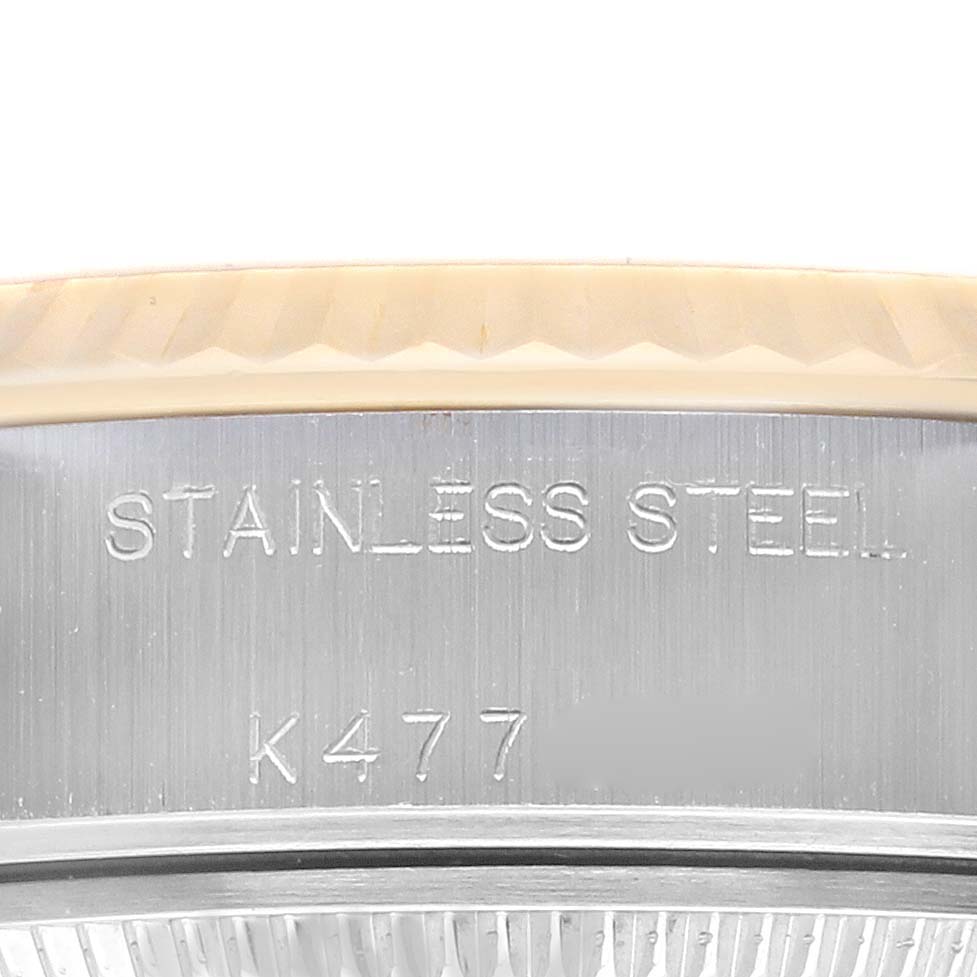 The image shows the side view of a Rolex Datejust 79173 Women
s Steel and Gold (two tone) Champagne Dial 79173 Women
s Steel and Gold (two tone) Champagne Dial watch case, highlighting the stainless steel material and engraving.