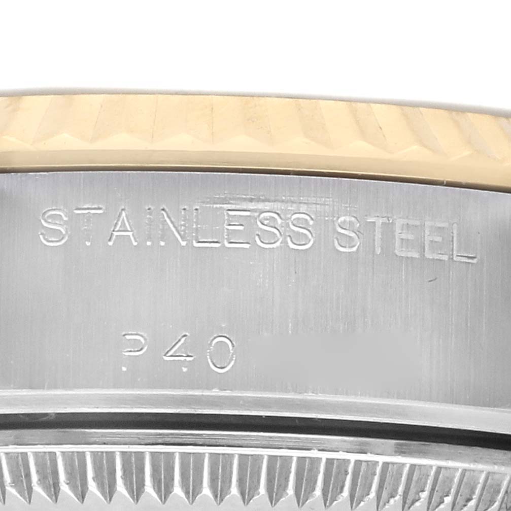 The image shows a close-up of the Rolex Datejust 79173 Women
s Steel and Gold (two tone) Champagne Dial 79173 Women
s Steel and Gold (two tone) Champagne Dial watch case edge, highlighting the stainless steel engraving and part of the fluted bezel.