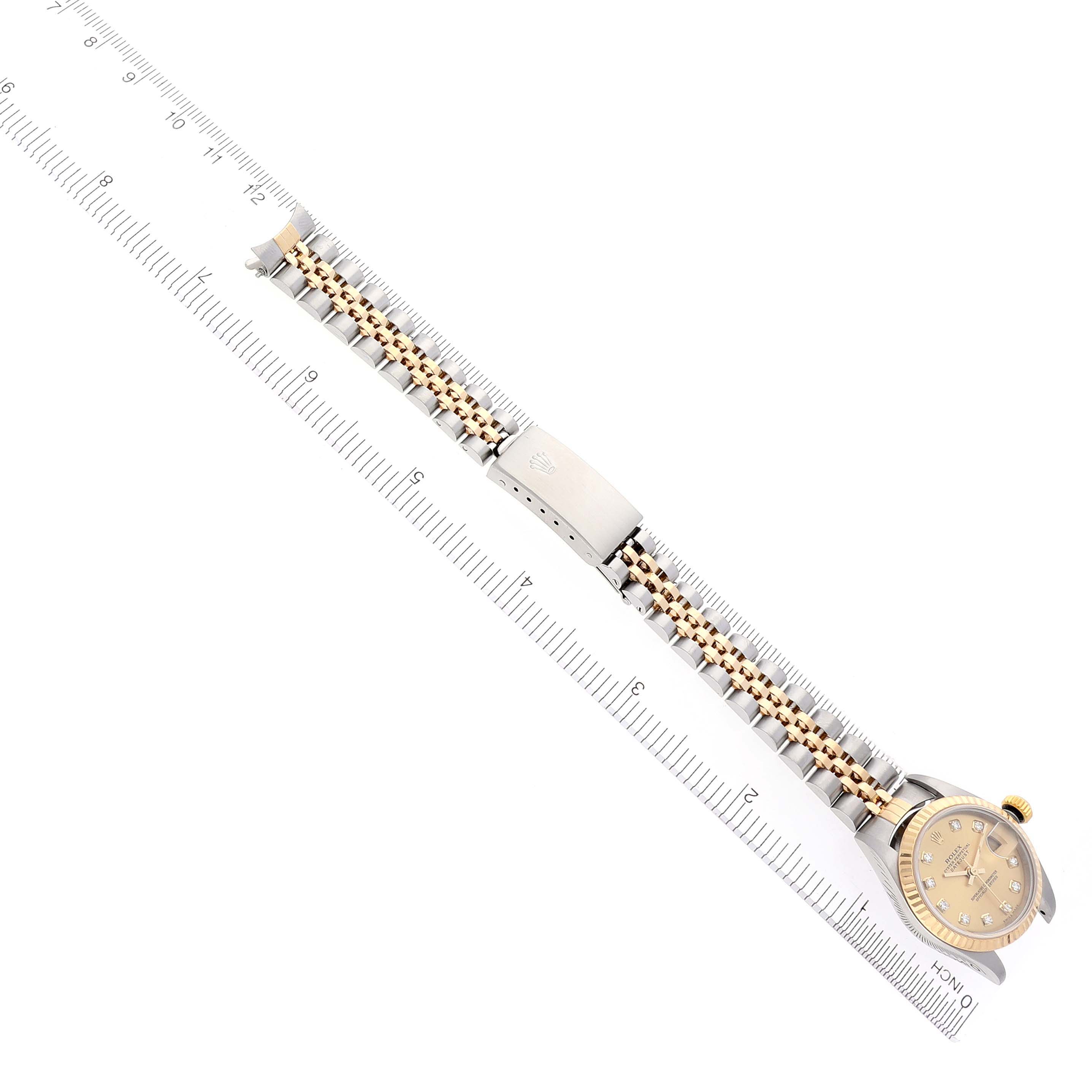 The Rolex Datejust 79173 Women
s Steel and Gold (two tone) Champagne Dial 79173 Women
s Steel and Gold (two tone) Champagne Dial watch is shown from a top angle, highlighting its face and bracelet with a clasp.