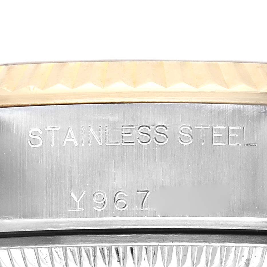 The image shows a close-up of the Rolex Datejust 79173 Women
s Steel and Gold (two tone) Champagne Dial 79173 Women
s Steel and Gold (two tone) Champagne Dial
s stainless steel side case with engraved markings.