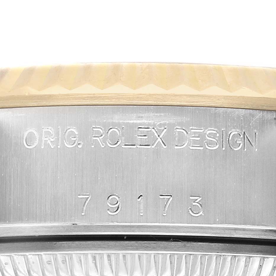 The image shows a close-up of the side of a Rolex Datejust 79173 Women
s Steel and Gold (two tone) Champagne Dial 79173 Women
s Steel and Gold (two tone) Champagne Dial, highlighting "ORIG. ROLEX DESIGN" and model number 79173.