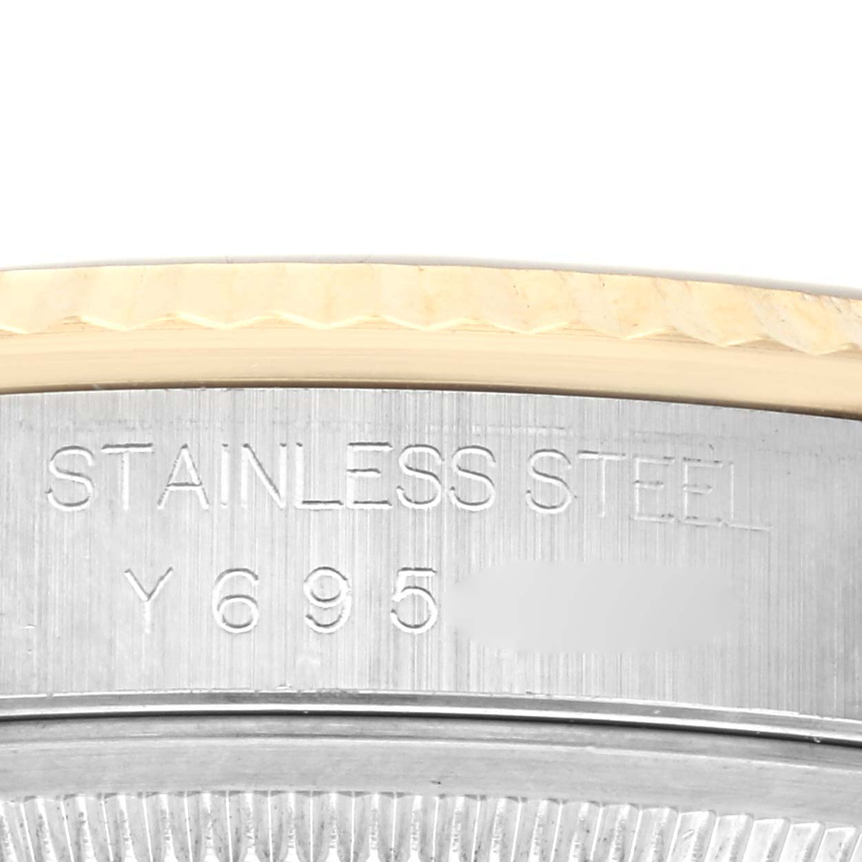 The image shows a close-up of the engraved stainless steel side of a Rolex Datejust 16233 Men's Steel and Gold (two tone) Champagne Dial 16233 Men's Steel and Gold (two tone) Champagne Dial watch.