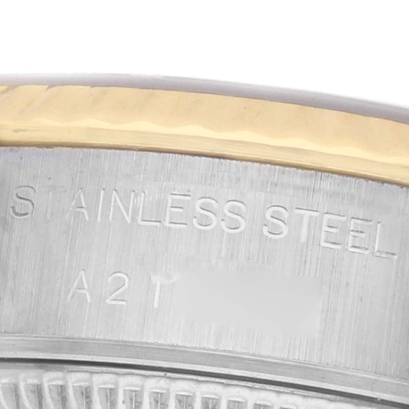 The image shows a close-up of the stainless steel case band edge of a Rolex Datejust 79173 Women's Steel and Gold (two tone) Champagne Dial.