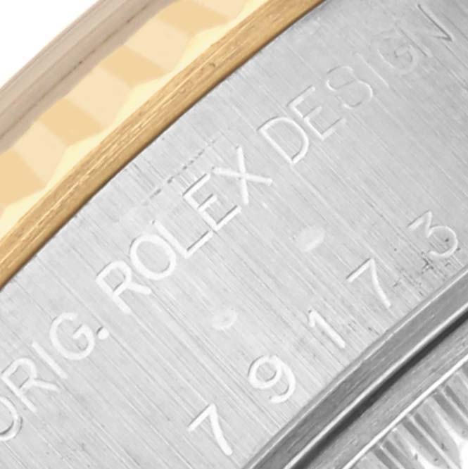 The image shows a close-up of the side engraving on a Rolex Datejust 79173 Women
s Steel and Gold (two tone) Champagne Dial 79173 Women
s Steel and Gold (two tone) Champagne Dial bezel and case.