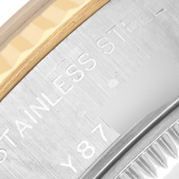 The image shows a close-up of the Rolex Datejust 79173 Women
s Steel and Gold (two tone) Champagne Dial 79173 Women
s Steel and Gold (two tone) Champagne Dial
s case edge, text engraving, and part of the bezel.