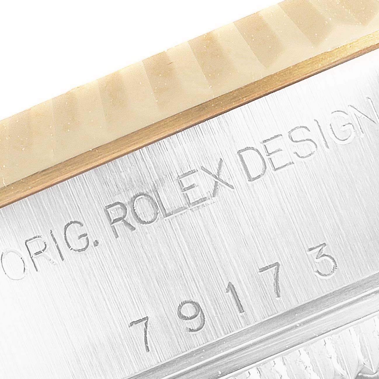 The image shows a close-up of the Rolex Datejust 79173 Women
s Steel and Gold (two tone) Mother of Pearl Dial 79173 Women
s Steel and Gold (two tone) Mother of Pearl Dial model
s bezel and case engraving.