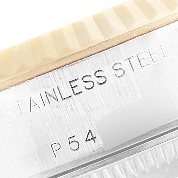 This close-up image shows the side engraving of a stainless steel Rolex Datejust 79173 Women
s Steel and Gold (two tone) Mother of Pearl Dial 79173 Women
s Steel and Gold (two tone) Mother of Pearl Dial watch, highlighting part of the bezel and case. 
