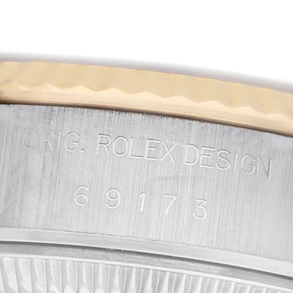 The image shows a close-up of the case side and engraved serial number of a Rolex Datejust 69173 Women's Steel and Gold (two tone) Champagne Dial watch.