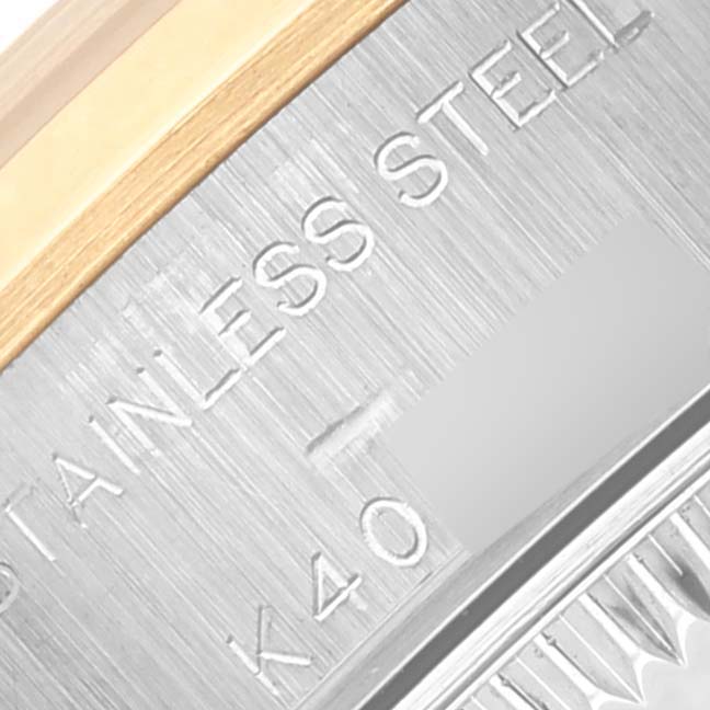 The image shows a close-up of the Rolex Datejust 79163 Women's Steel and Gold (two tone) Silver Dial 79163 Women's Steel and Gold (two tone) Silver Dial watch, highlighting the engraved stainless steel case and fluted bezel.