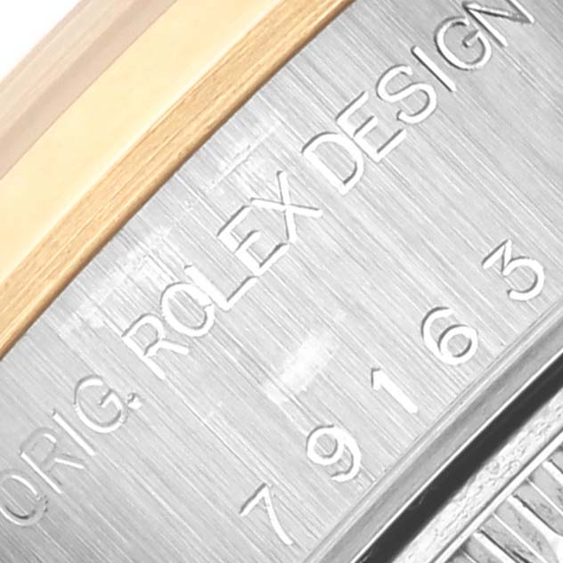 The image shows a close-up of the outer rim with engraved text on the Rolex Datejust 79163 Women's Steel and Gold (two tone) Silver Dial 79163 Women's Steel and Gold (two tone) Silver Dial watch.