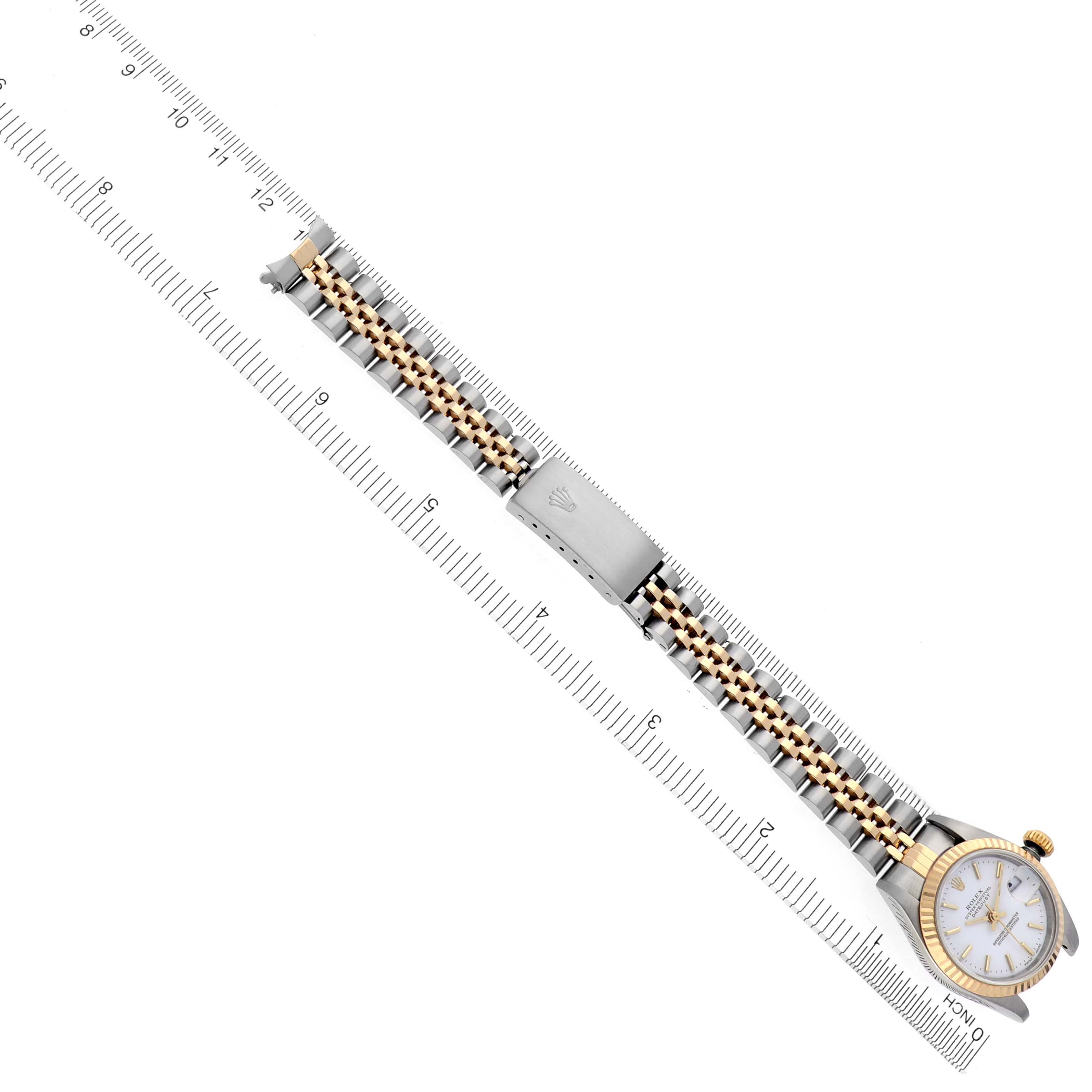 The image shows a Rolex Datejust 79173 Women's Steel and Gold (two tone) White Dial 79173 Women's Steel and Gold (two tone) White Dial watch laid flat along a ruler, displaying the bracelet and watch face.