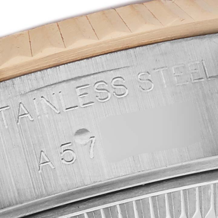 The image shows a close-up of the side of a Rolex Datejust 79173 Women's Steel and Gold (two tone) White Dial 79173 Women's Steel and Gold (two tone) White Dial, focusing on the bezel and engraved stainless steel case.