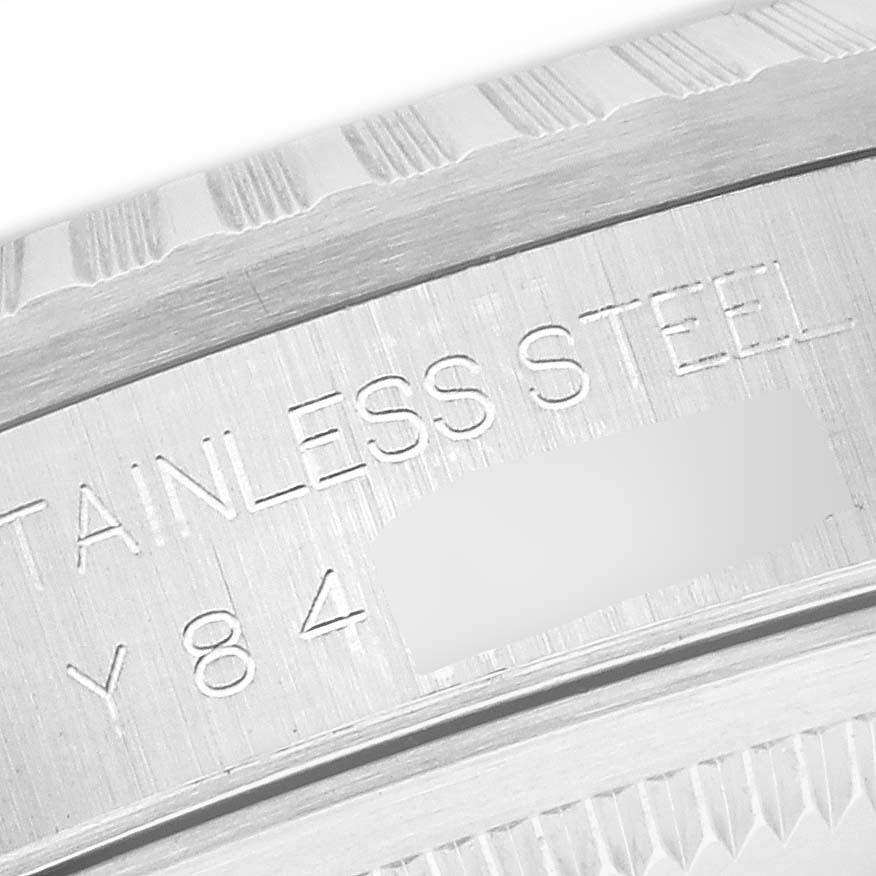 The image shows a close-up of the side engraving on the stainless steel bezel of a Rolex Datejust 16220 Men's Stainless Steel White Dial 16220 Men's Stainless Steel White Dial watch.