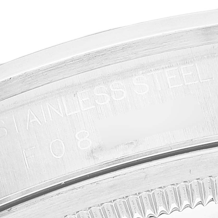 This image shows a partial close-up view of the stainless steel case back and fluted bezel of a Rolex Datejust 16200 Men's Stainless Steel White Dial 16200 Men's Stainless Steel White Dial watch.