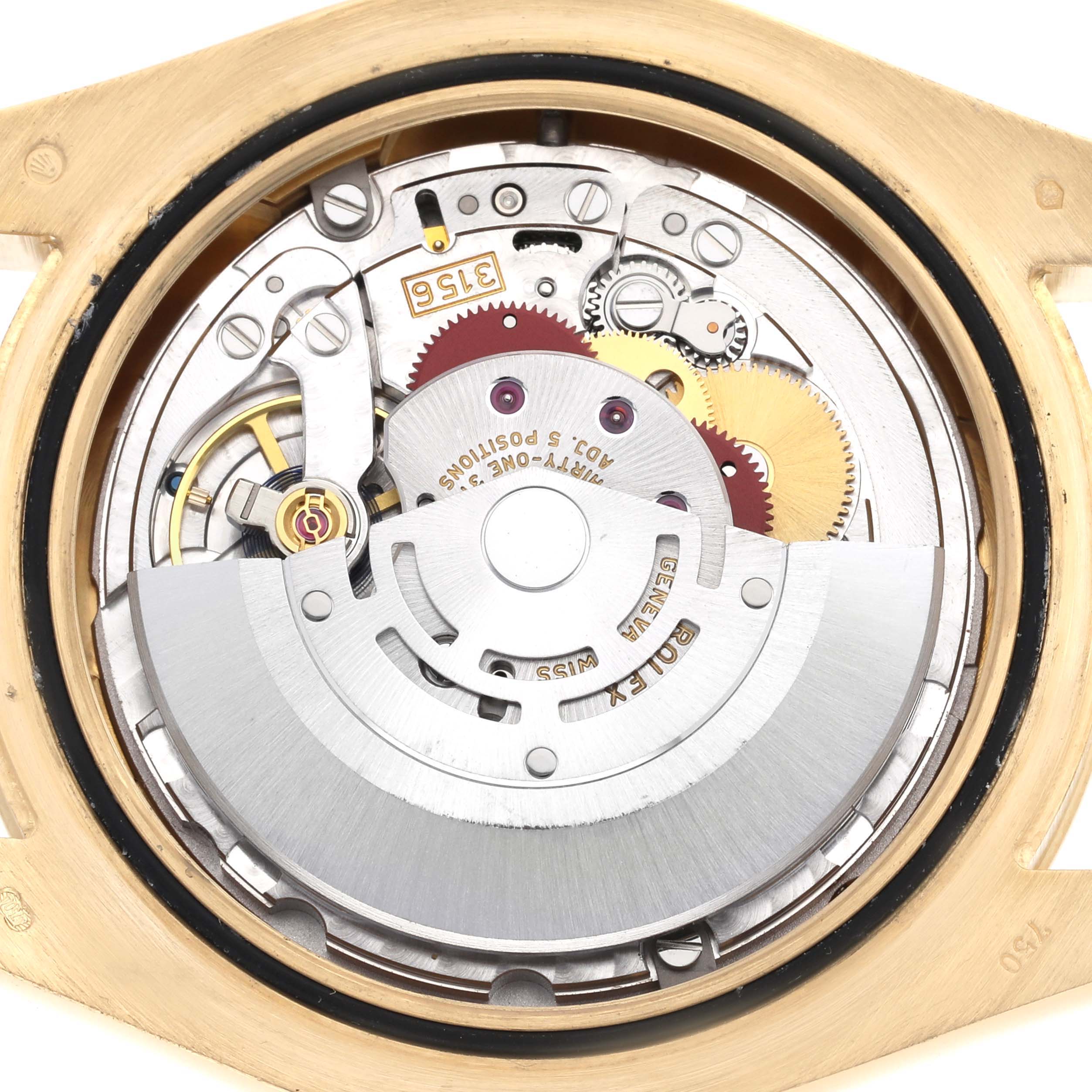 The image shows the intricate movement from the back of a Rolex President 218238 Men's Yellow Gold Champagne Dial model, highlighting gears and the rotor.