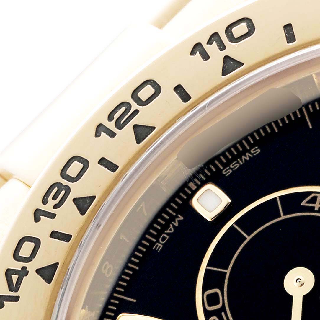 The image shows a close-up of the bezel and partial dial of a Rolex Daytona 116508 Men's Yellow Gold Black Dial, highlighting the tachymeter scale and hour markers.