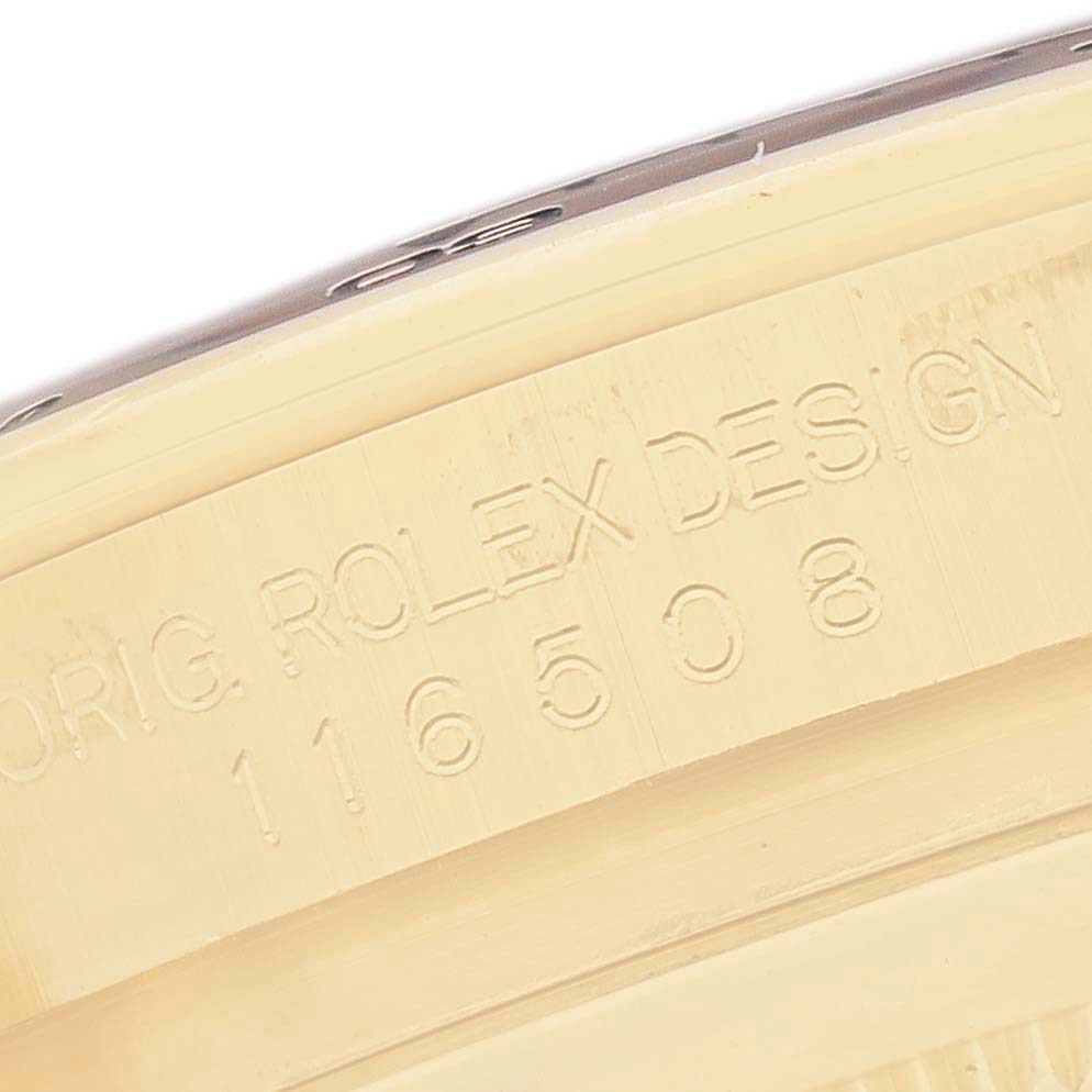 The image shows a close-up of engravings on the side of the Rolex Daytona 116508 Men's Yellow Gold Black Dial watch case, featuring the model and reference number.