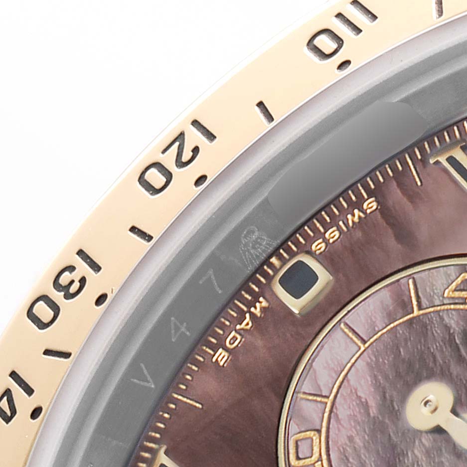 The image shows a close-up of the bezel and part of the dial on a Rolex Daytona 116523 Men's Steel and Gold (two tone) Mother of Pearl Dial watch.