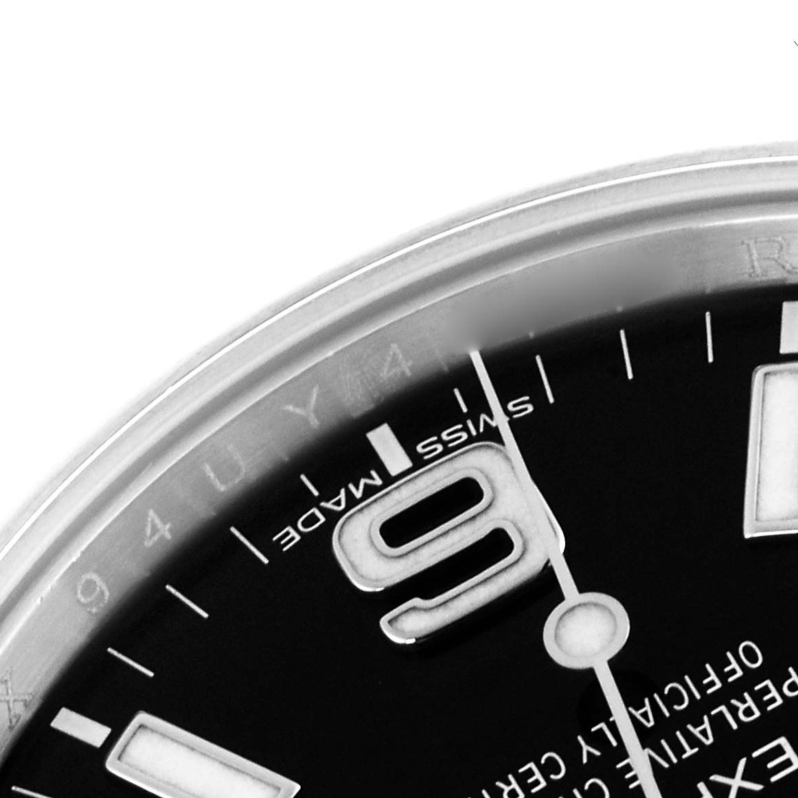 The image shows a close-up of the Rolex Explorer 214270 Men
s Stainless Steel Black Dial 214270 Men
s Stainless Steel Black Dial watch dial, focusing on the "9" numeral and part of the bezel.