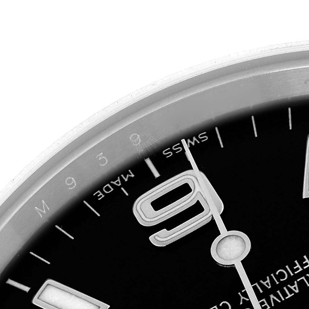 The image shows a close-up of the Rolex Explorer 114270 Men
s Stainless Steel Black Dial 114270 Men
s Stainless Steel Black Dial
s dial, focusing on the numeral 9 and surrounding markers.