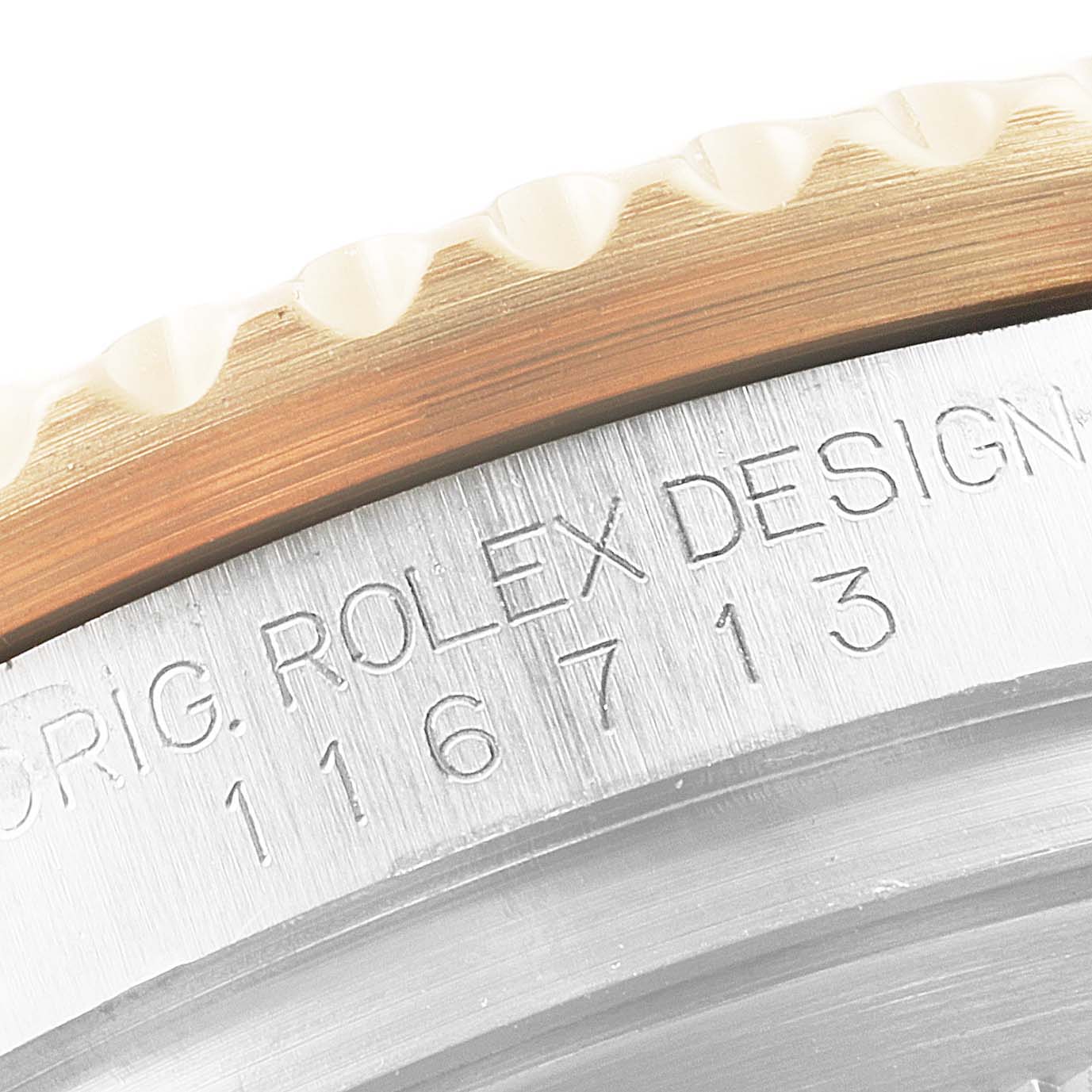 This close-up angle shows the bezel and part of the case with the model number and "ROLEX DESIGN" engraved on the Rolex GMT-Master 116713 Men's Steel and Gold (two tone) Black Dial 116713 Men's Steel and Gold (two tone) Black Dial.