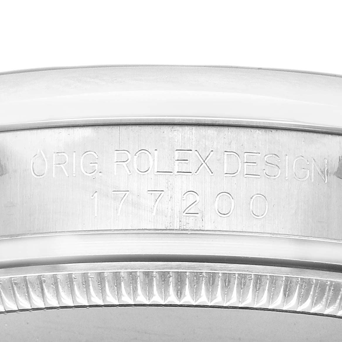 The image shows the side view of a Rolex Mid-Size 177200 Women's Stainless Steel Black Dial watch, focusing on the engraved model number and design details.