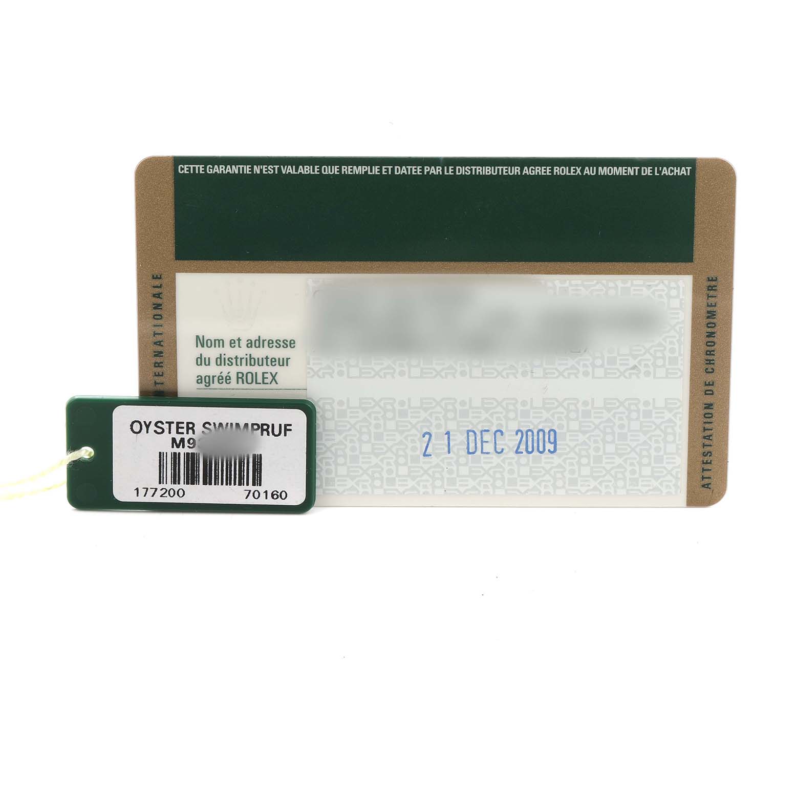The image shows a Rolex Oyster watch warranty card and a green tag with model information.