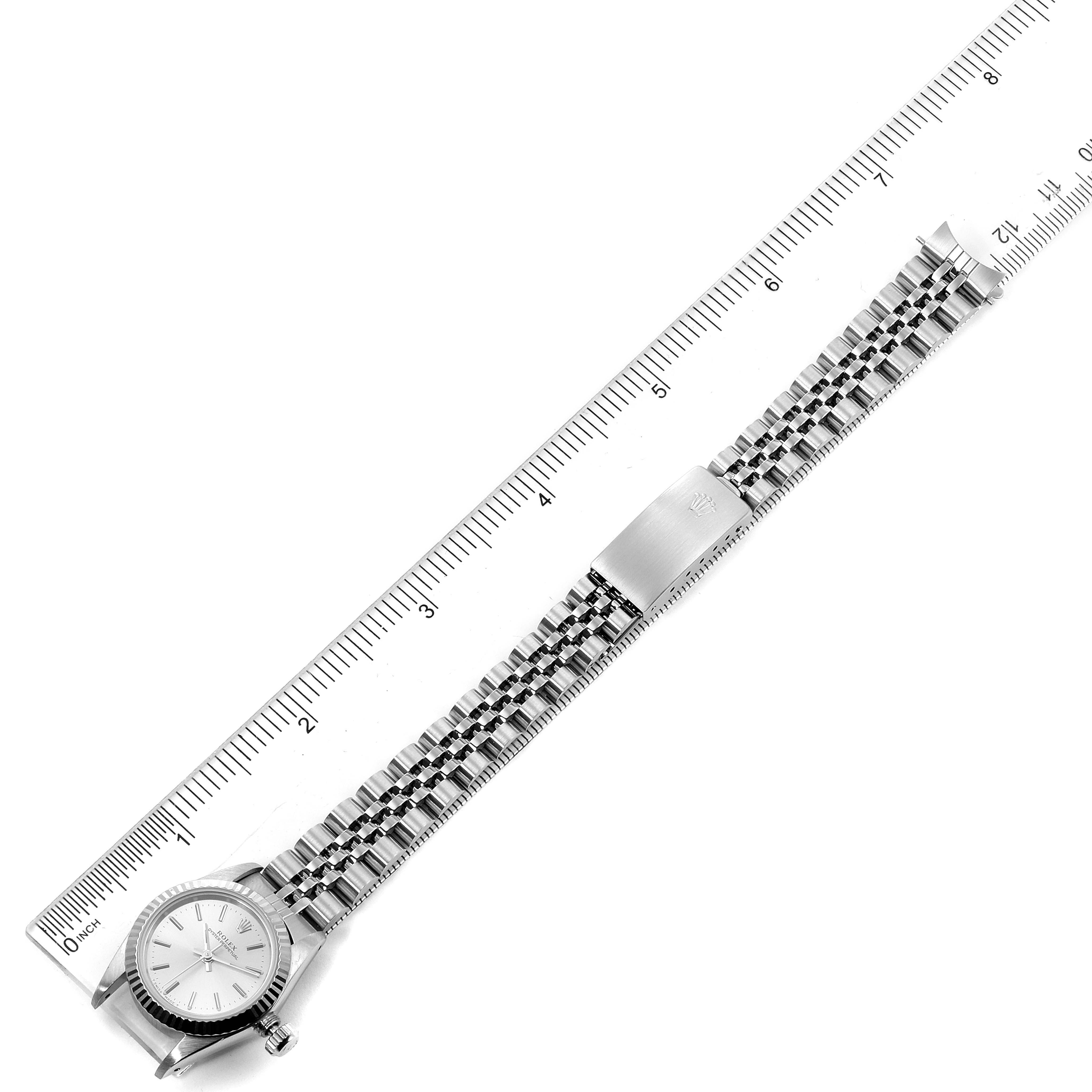 The image shows a Rolex Oyster Perpetual 67194 Women's Stainless Steel Silver Dial 67194 Women's Stainless Steel Silver Dial watch laid flat, with a ruler measuring its length.