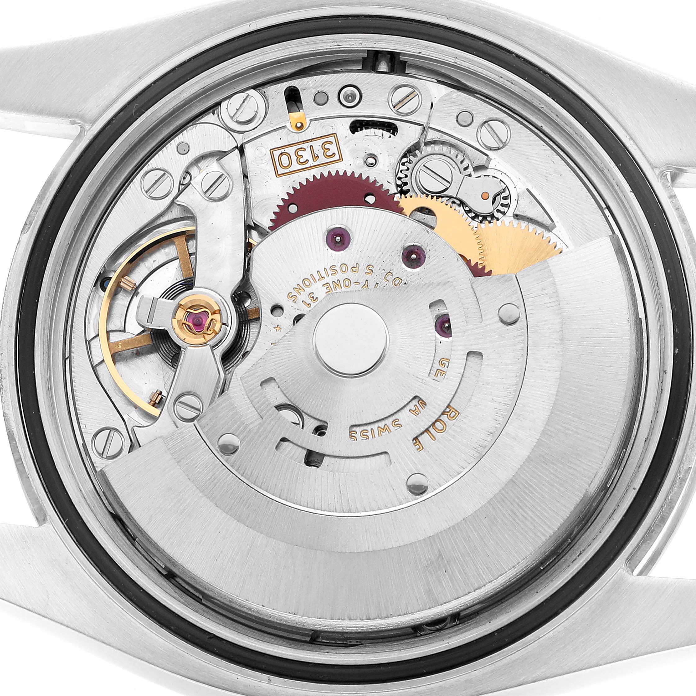 The image shows the movement mechanism of a Rolex Oyster Perpetual 76276 Men's Stainless Steel Silver Dial, viewed from the back with cogs and gears visible.