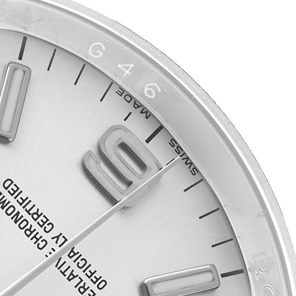 The image shows a close-up of the dial of a Rolex Oyster Perpetual 76276 Men's Stainless Steel Silver Dial, highlighting the "9" and "Swiss Made" text.