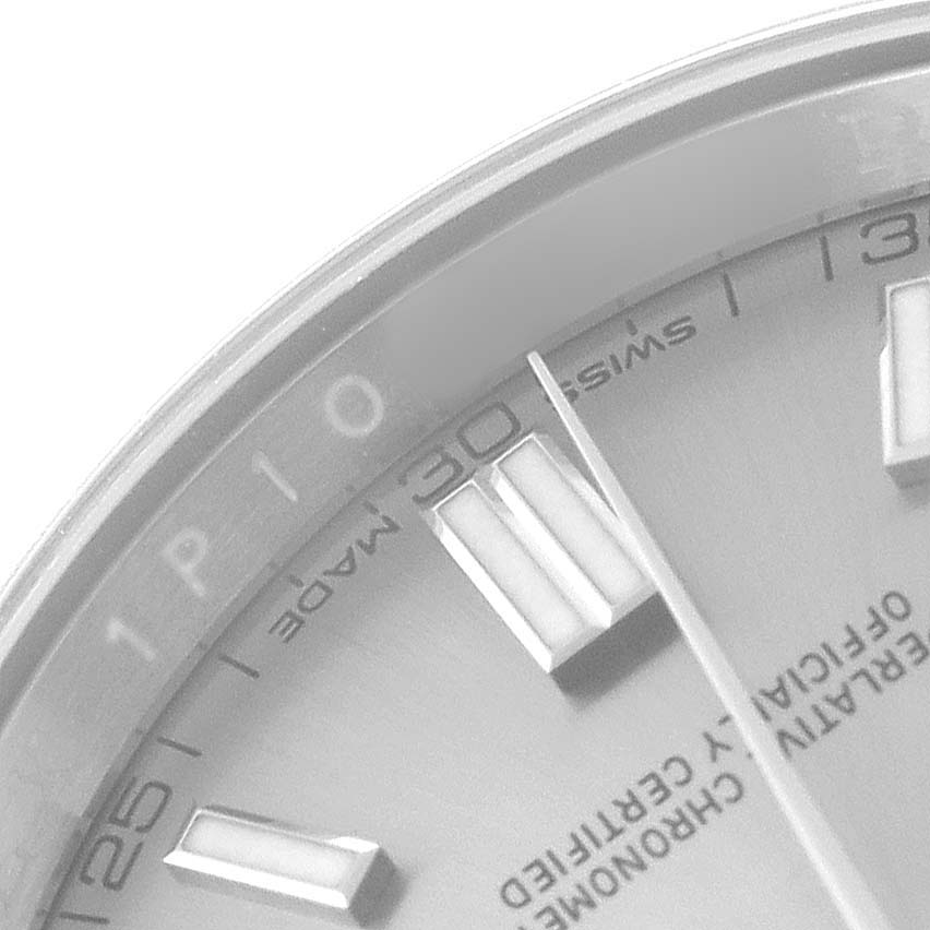 The image shows a close-up of the Rolex Oyster Perpetual 116000 Men's Stainless Steel Silver Dial model, focusing on the dial, hour markers, and part of the bezel.