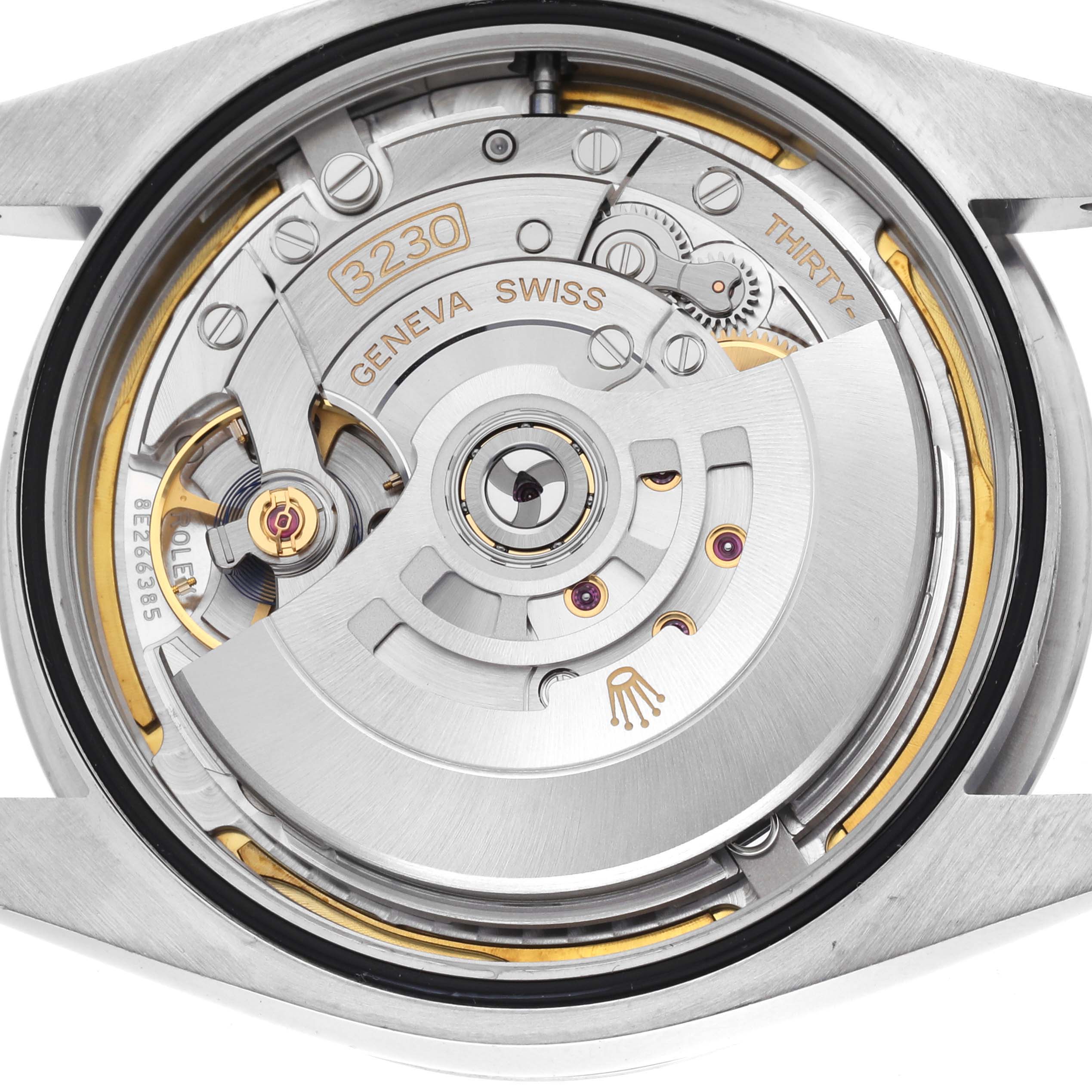 The image shows the exposed movement of a Rolex Oyster Perpetual 124300 Men's Stainless Steel Green Dial watch, displaying the intricate inner mechanics.