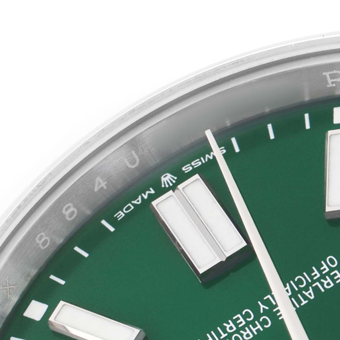 The image shows a close-up of the Rolex Oyster Perpetual 124300 Men's Stainless Steel Green Dial's green dial, partial indices, and hands.