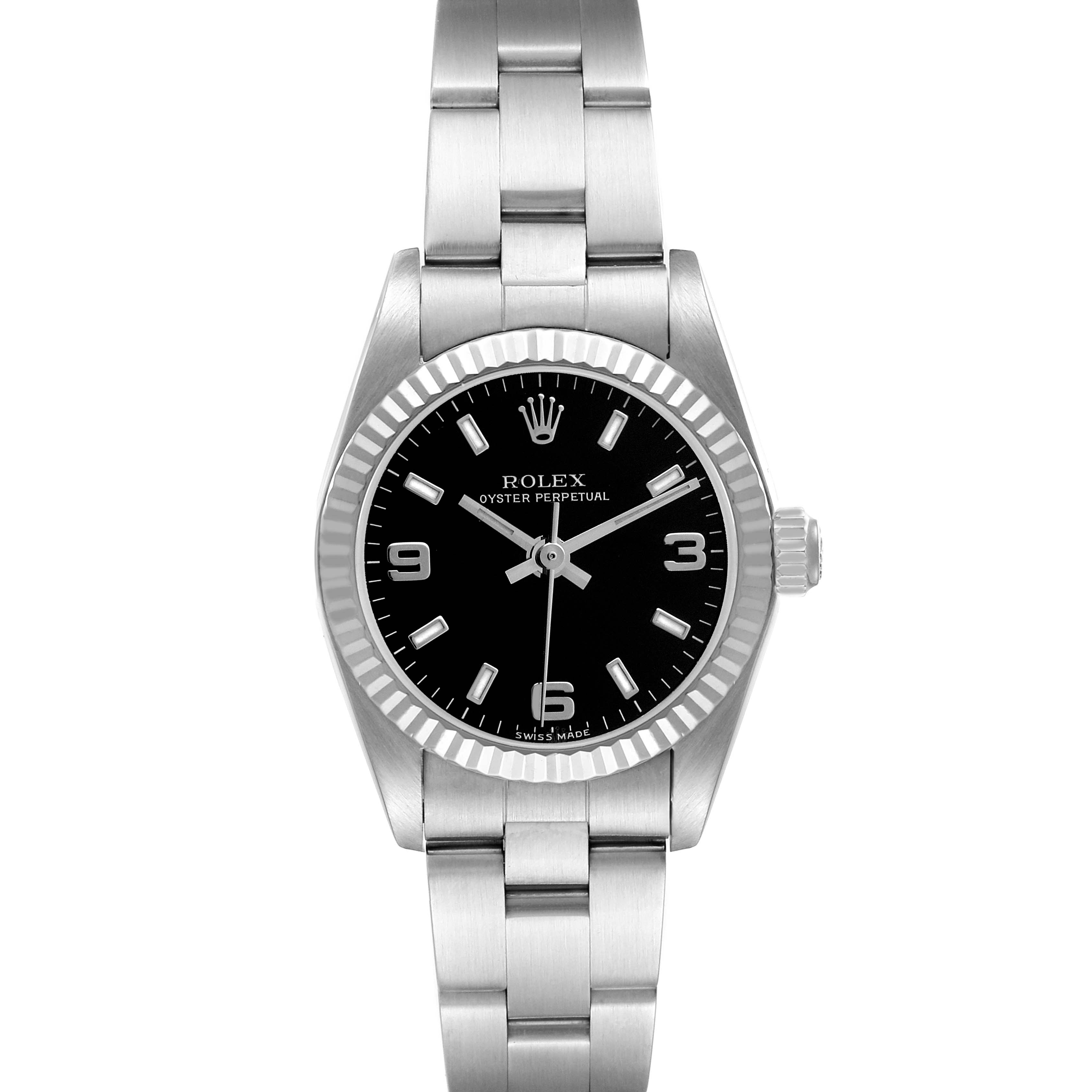 The Rolex Oyster Perpetual 76094 Women's Stainless Steel Black Dial watch is shown from a top-down angle, highlighting its face, bezel, crown, and bracelet.