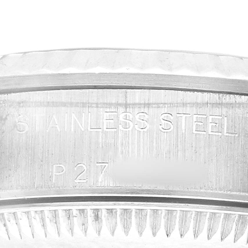 The image shows a close-up of the rim and edge of a Rolex Oyster Perpetual 76094 Women's Stainless Steel Black Dial watch, highlighting the stainless steel engraving.