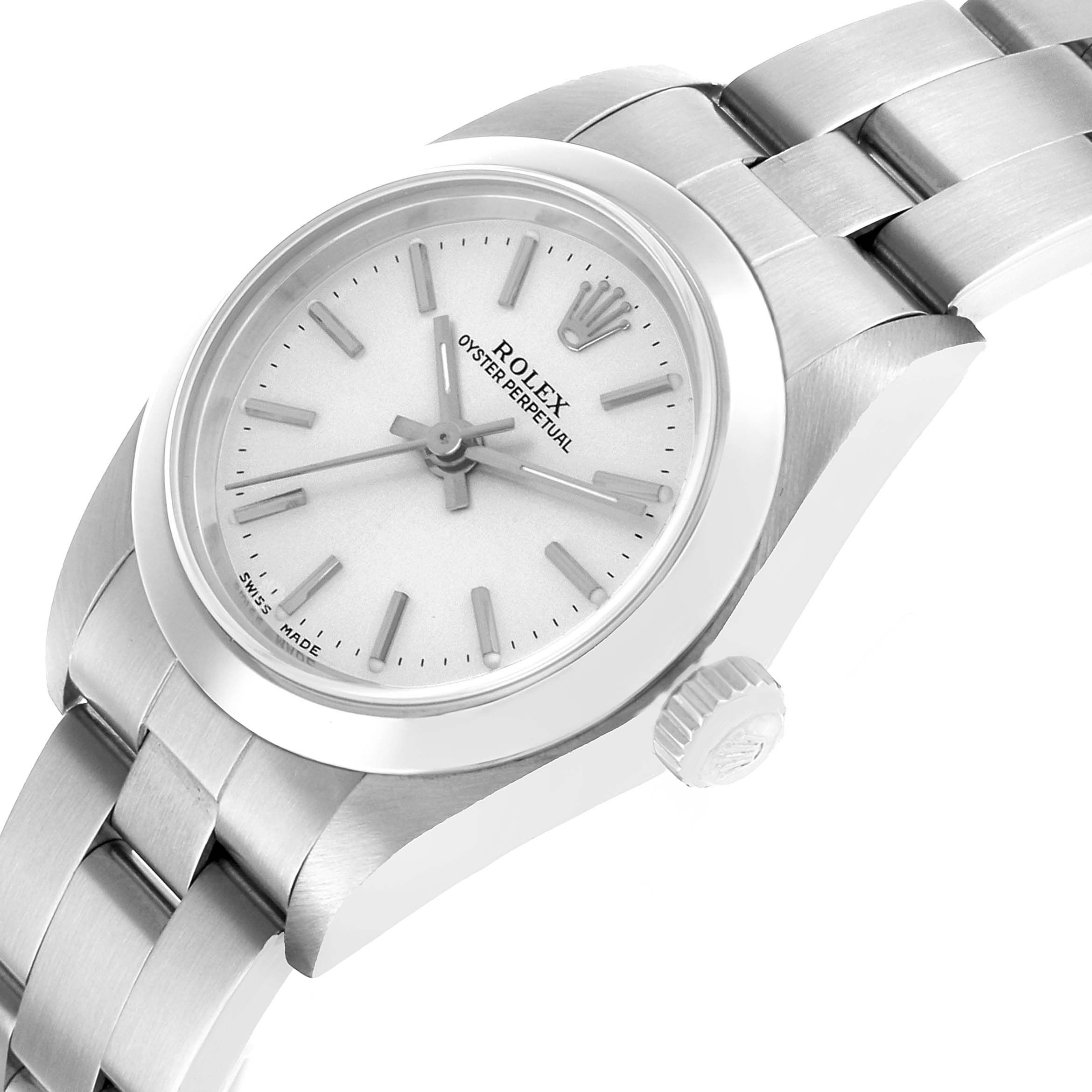 The Rolex Oyster Perpetual 76080 Women's Stainless Steel Silver Dial watch is shown at an angled top-side view, displaying the face, bezel, crown, and bracelet.